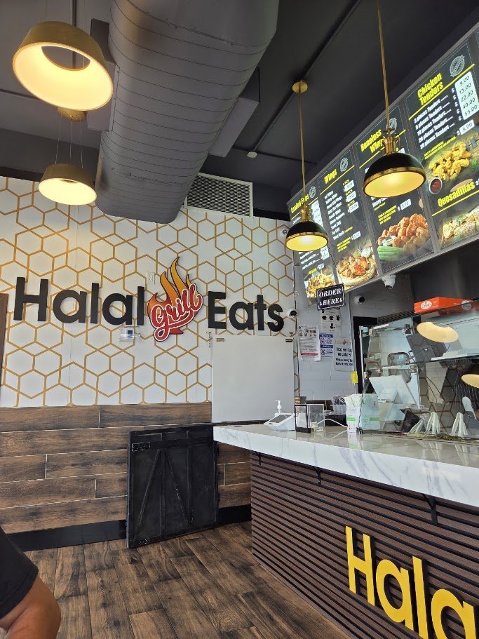 Counter with menu boards and food trays.