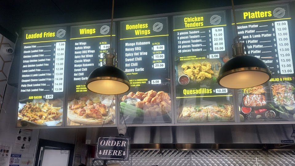 Restaurant menu with wings and salads.